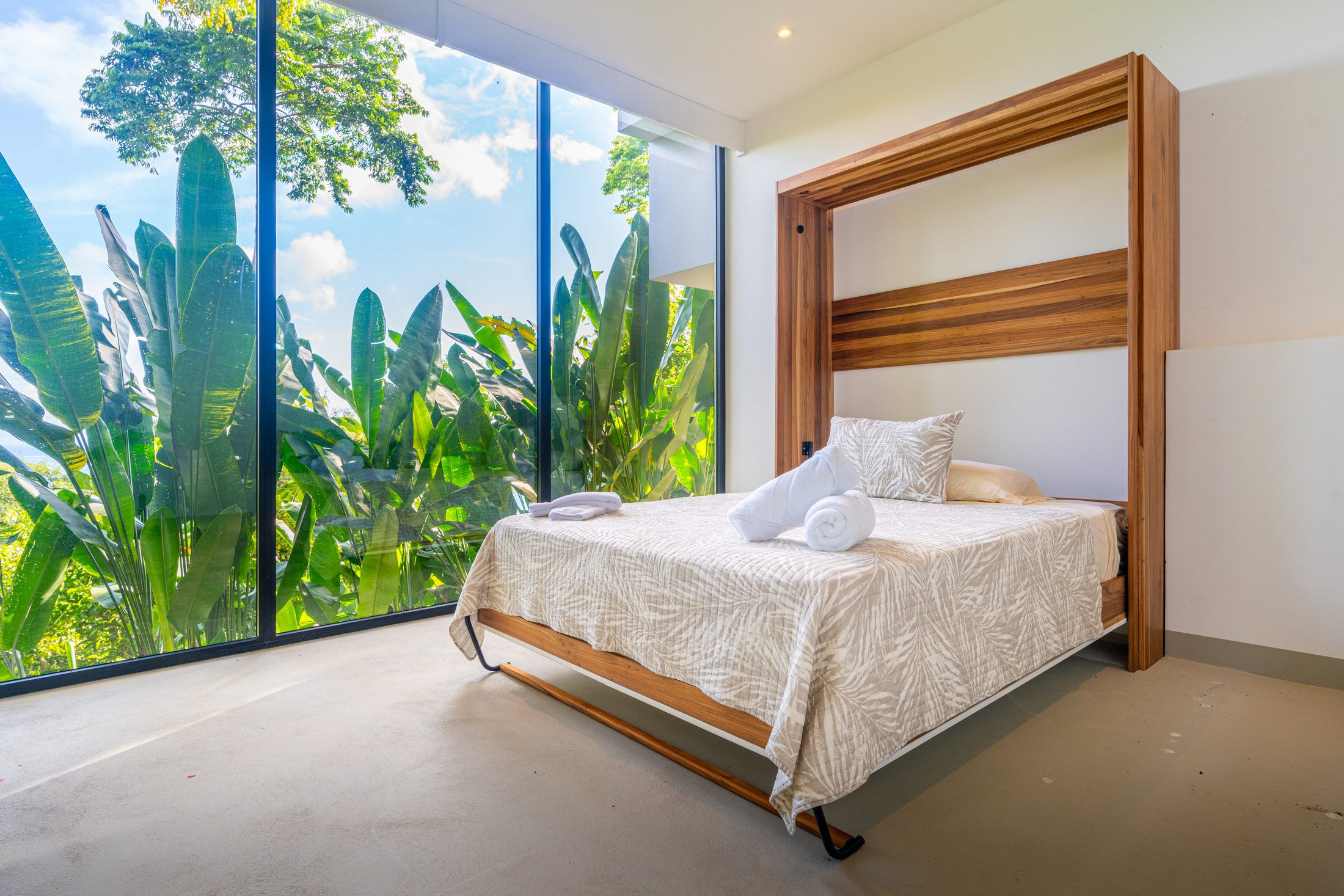 Bedroom framed by foliage